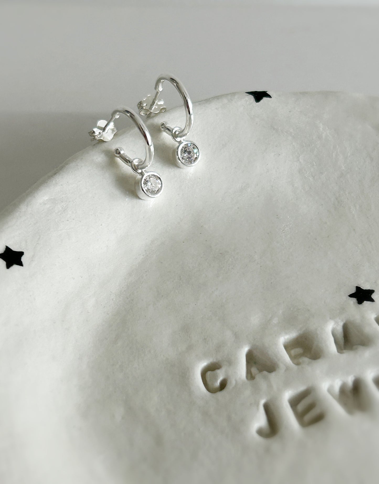 Super sparkly Cubic zirconia droplet charm earrings on a Sterling Silver hoop.
The hoop earrings can also be worn alone as the charms can be easily removed from the hoops for a versatile earring design.