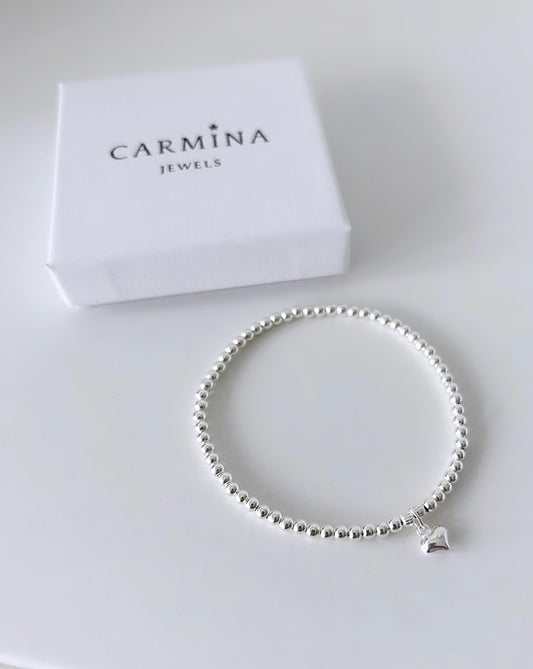 A sterling silver bead bracelet with a small heart charm