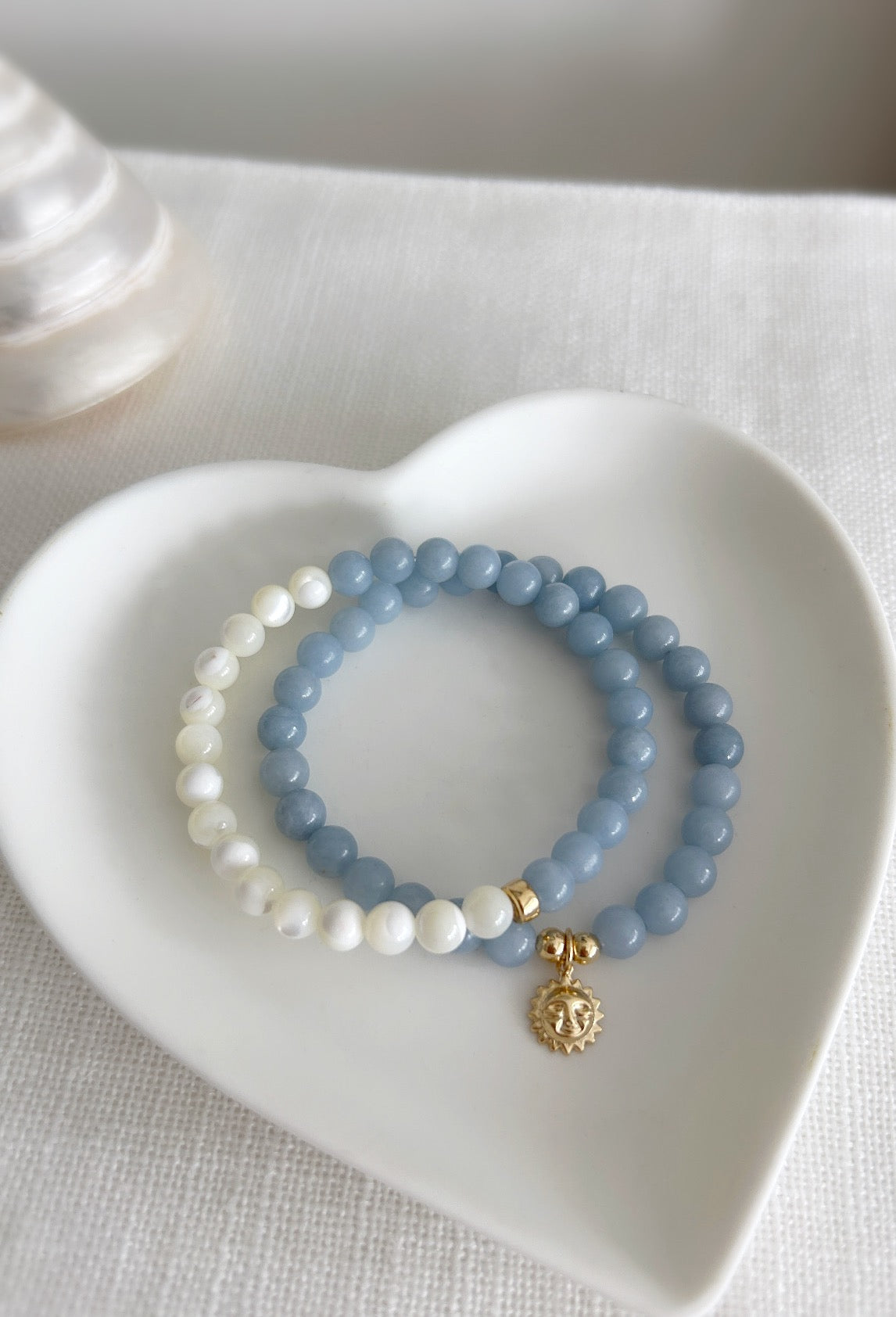 Angelite bead bracelet on a stretch cord with a gold filled sun face charm