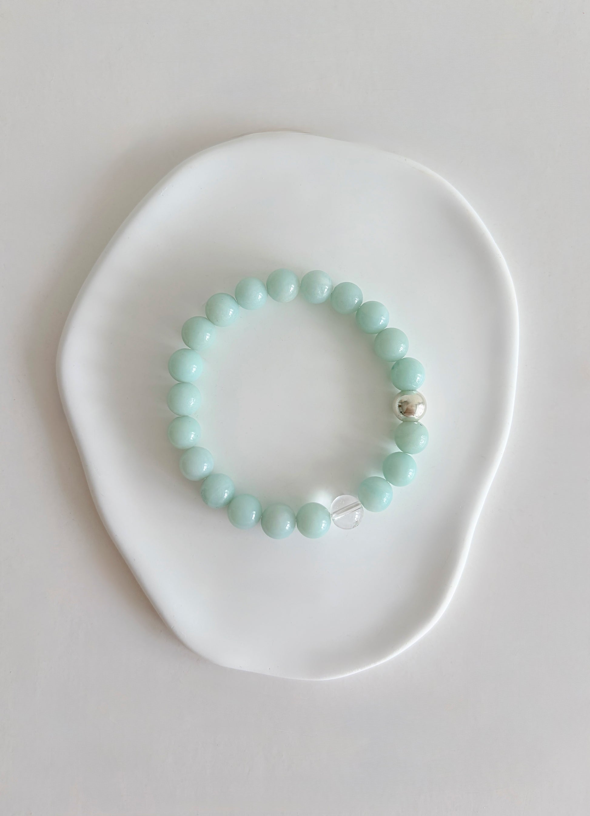 A beautiful Summer vibe Semi precious beaded Amazonite stacking bracelet with a Silver or Gold accent bead and clear quartz bead, hand threaded on a stretch cord. 
