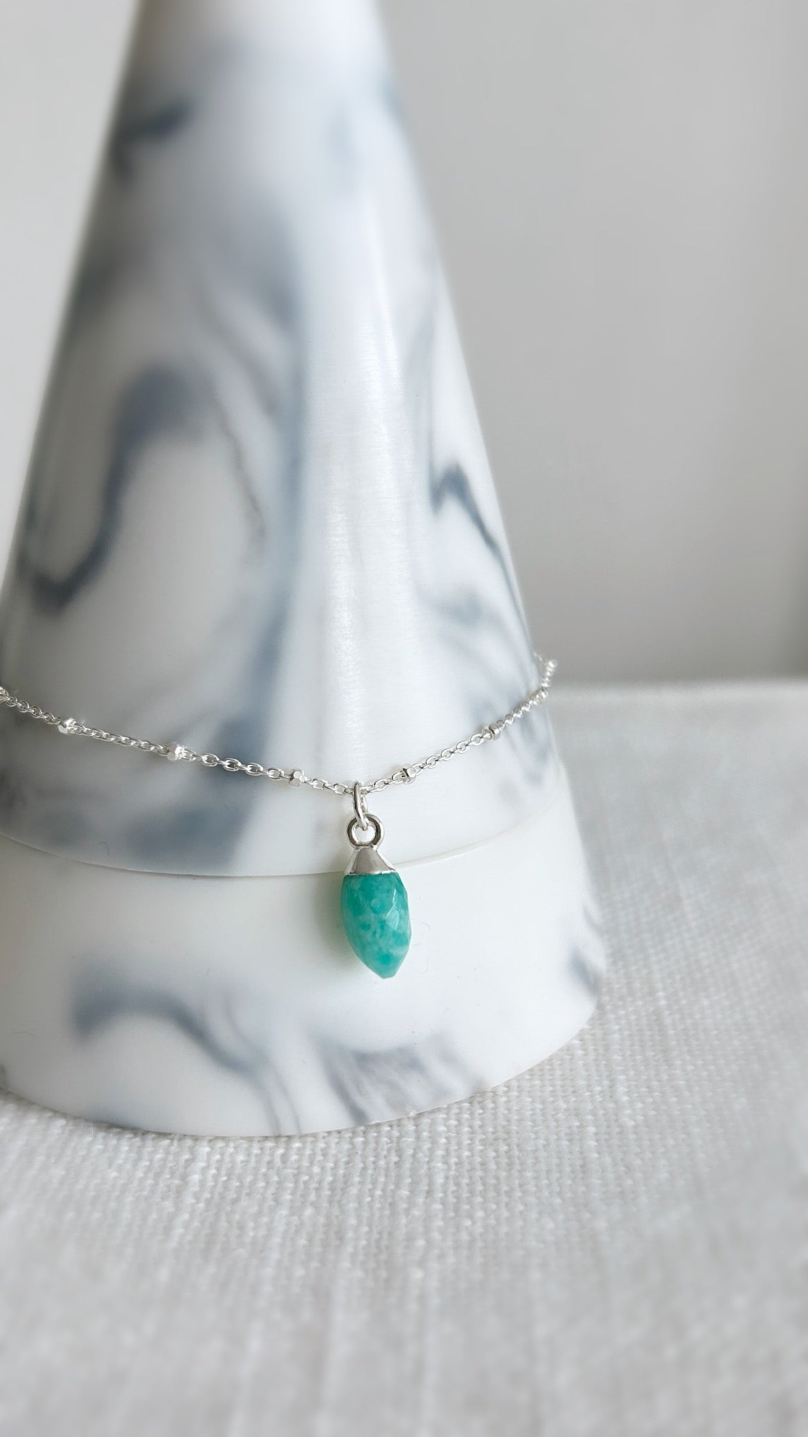 A beautiful sparkly Silver satellite chain bracelet with a semi precious Amazonite marquise droplet charm. 
