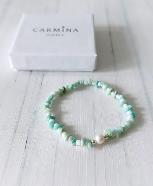 An Amazonite gemstone beaded bracelet with white beads, and a single freshwater pearl