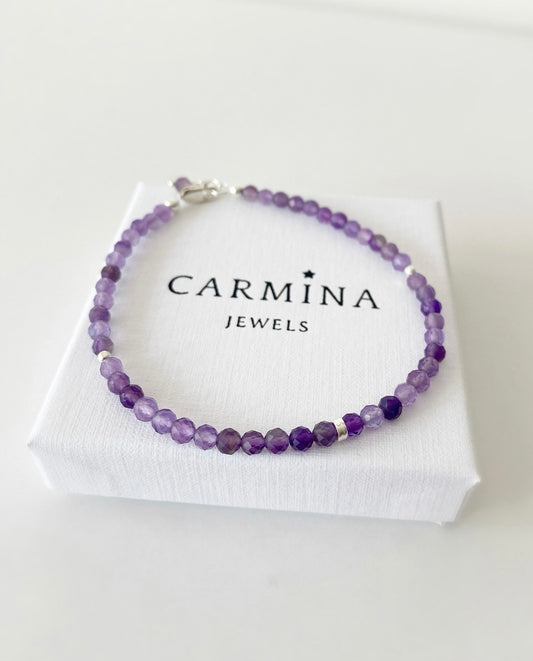 An amethyst crystal bracelet with faceted beads and a lobster clasp