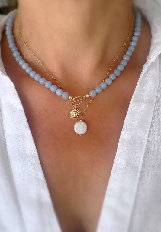 A beautiful baby blue Angelite necklace, with a glorious Gold filled Sun face charm