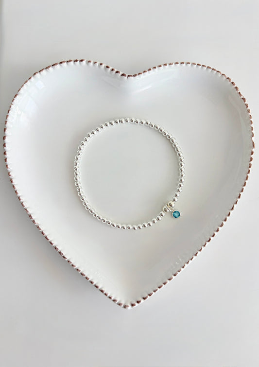 The Birthstone Bracelet is a meaningful, personalised keepsake designed to celebrate the people you love. Each vibrant crystal charm represents a birthstone, symbolising either your own birthstone, a family member or a loved one close to your heart. The bracelet is made with delicate 3mm Silver or Gold Filled beads