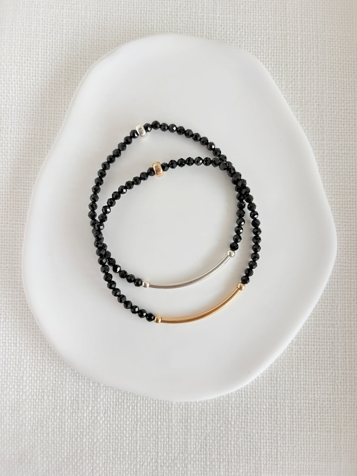 Beautiful Black Spinel semi precious faceted bead bracelet hand threaded on a strong stretch elastic cord. This delicate bracelet comes in a choice of two finishes using either Sterling Silver or Gold Filled accents.