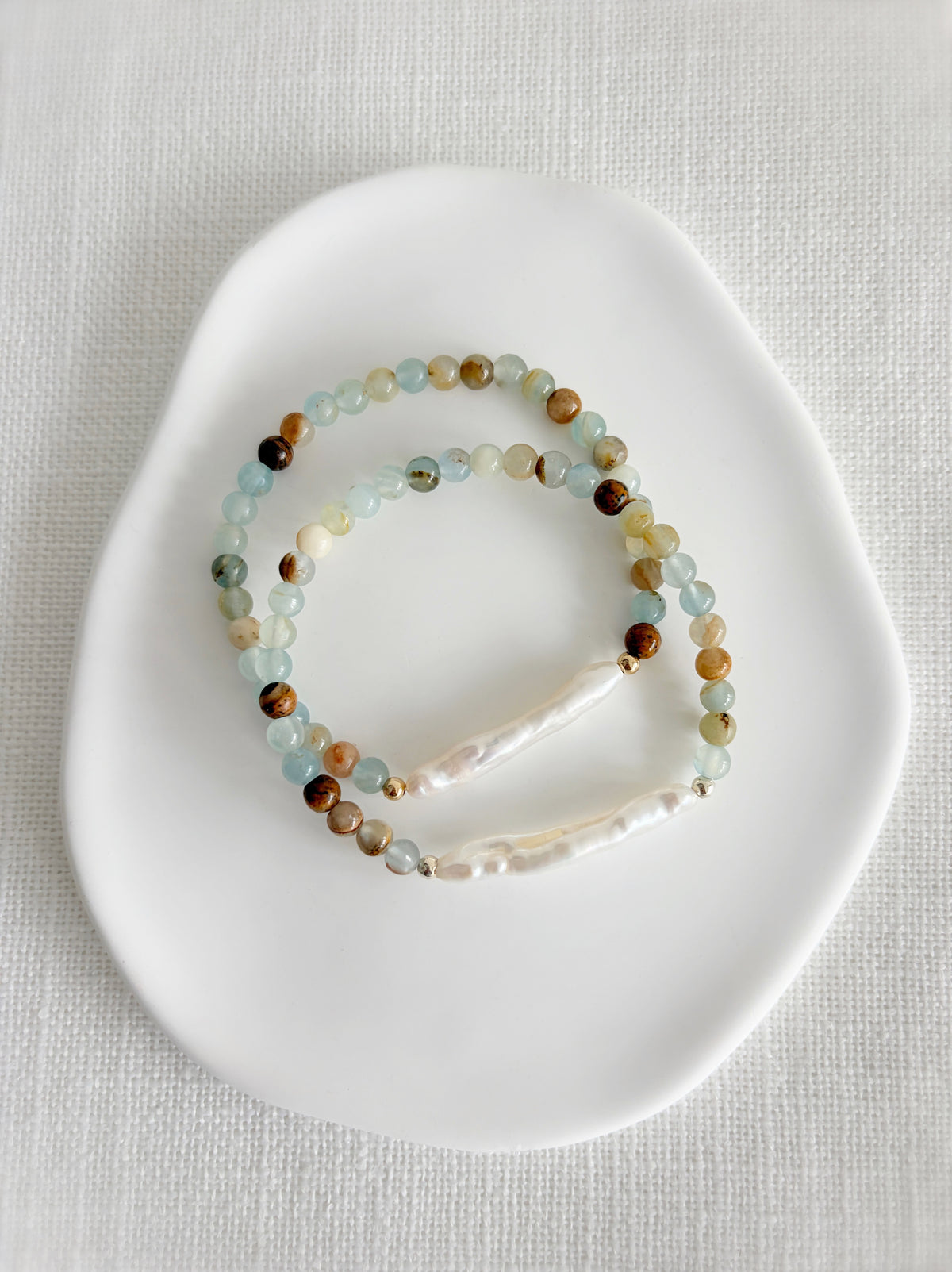 Blue calcite semi precious beaded bracelet,featuring a Biwa Freshwater Pearl hand threaded on a high quality stretch cord. Choose from either a Sterling silver, or Gold Filled finish.