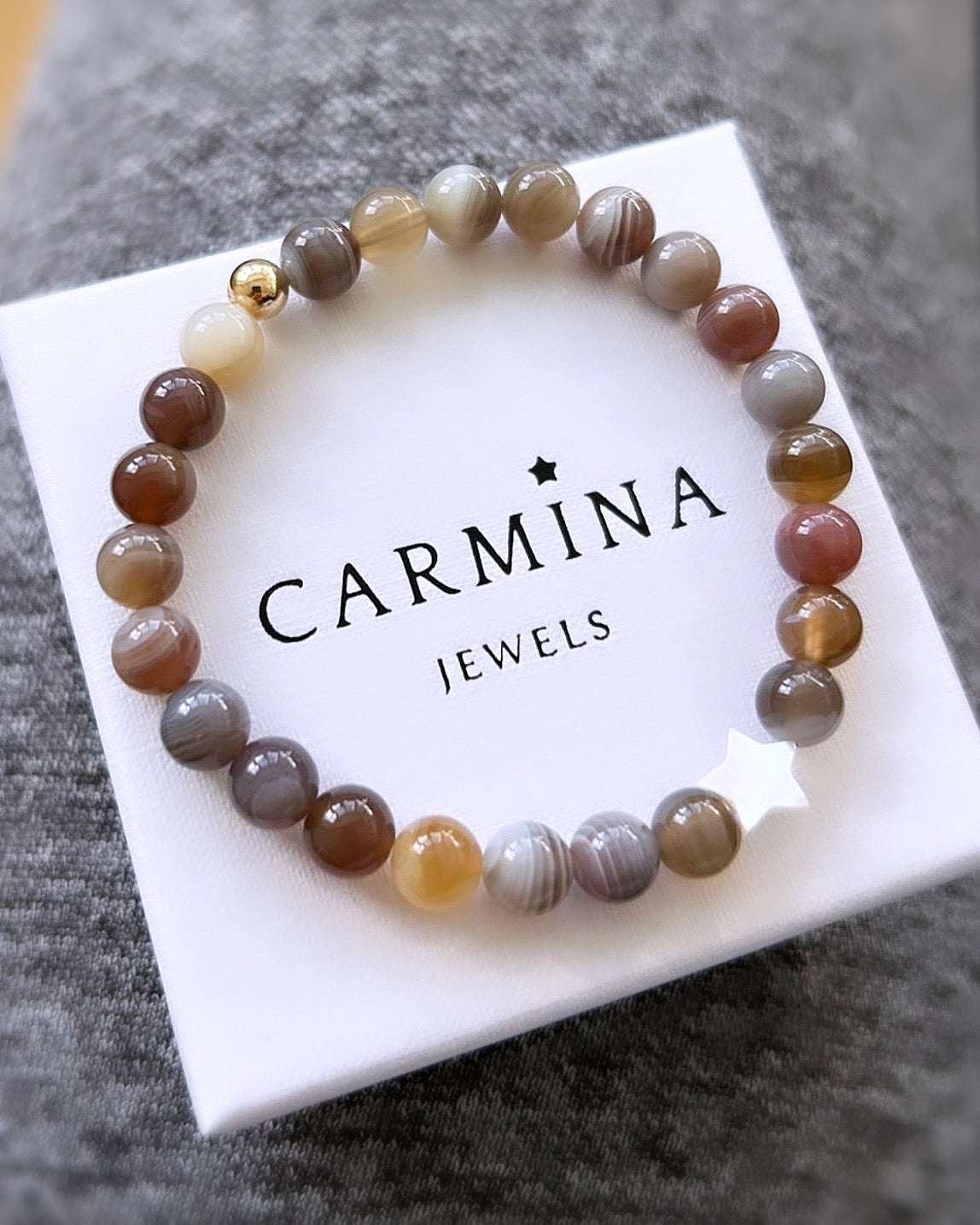 A gorgeous Semi precious beaded Botswana Agate bracelet on a stretch cord with mother of pearl. 

The Bracelet is available with a Sterling Silver or Gold Filled spacer bead and with either a Mother of Pearl heart or star bead
