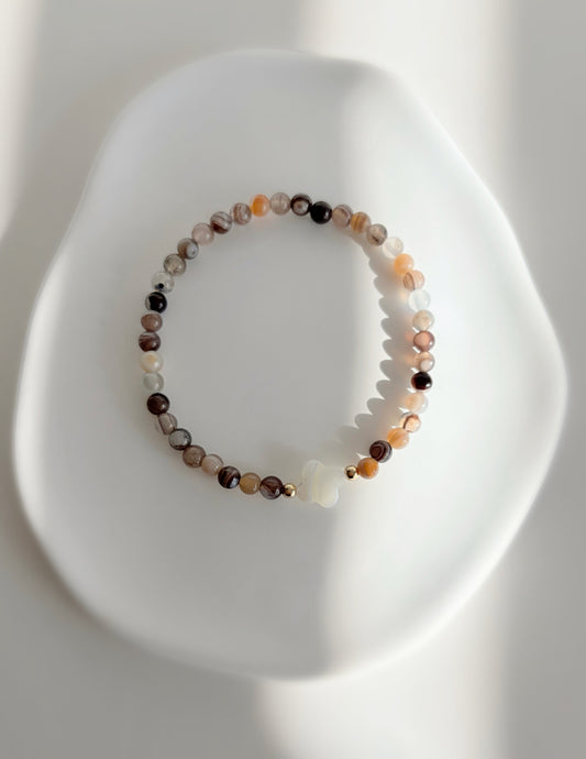 A beautiful Semi precious beaded Botswana Agate bracelet with a central Mother of Pearl clover bead, hand threaded on a high quality stretch cord.
