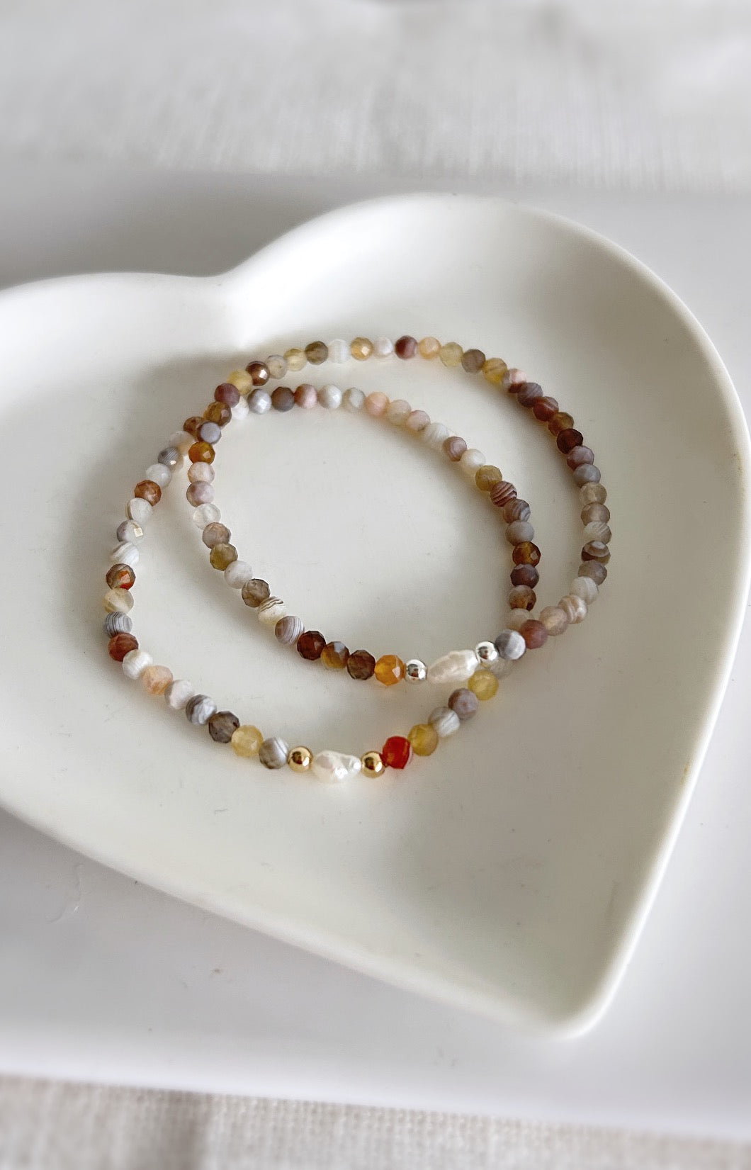 Beautiful Botswana Agate semi precious faceted bead bracelet. This delicate bracelet comes in a choice of two finishes using either Sterling Silver or Gold Filled spacer beads with a central Freshwater rice Pearl. 