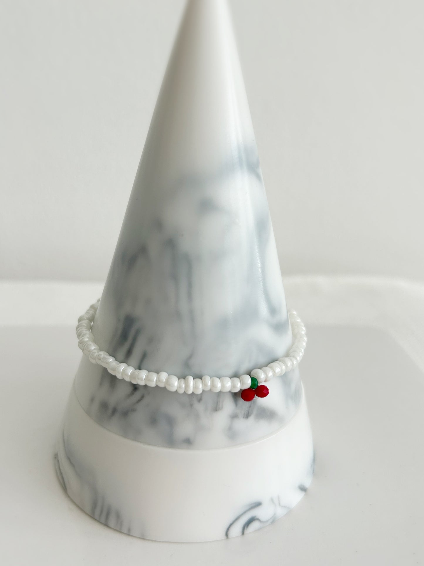 A sweet white glass seed bead bracelet with a single crystal glass cherry design ~ hand threaded with Miyuki glass and crystal glass faceted beads finished with a choice of a Sterling Silver or Gold Filled clasp. 