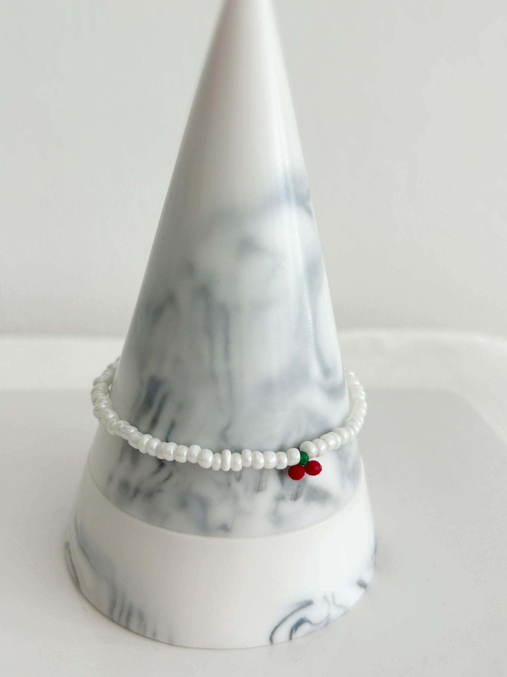 A sweet white glass seed bead bracelet with a single crystal glass cherry design ~ hand threaded with Miyuki glass and crystal glass faceted beads finished with a choice of a Sterling Silver or Gold Filled clasp. 