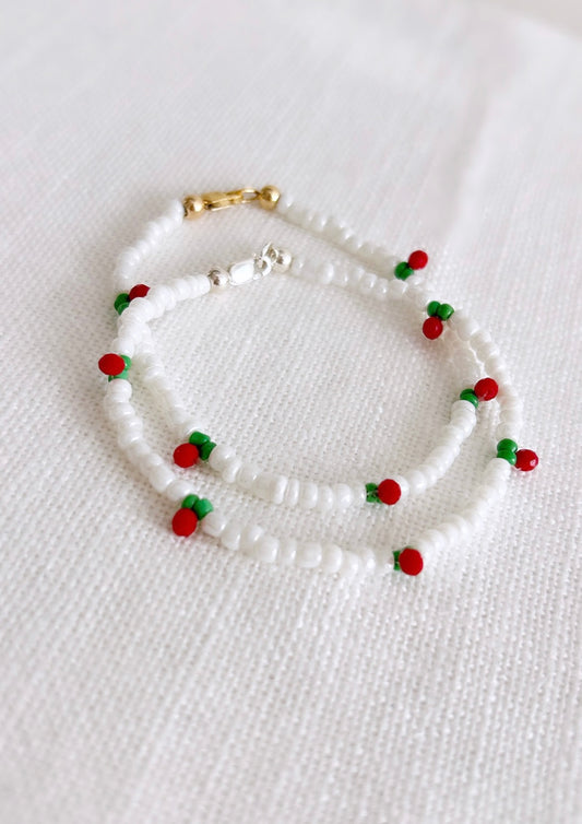 A sweet seed bead Cherry bracelet hand threaded with Miyuki glass and crystal glass faceted beads finished with a choice of a Sterling Silver or Gold Filled clasp. 

This dainty piece features a pretty row of cherries design on a white beaded base. 