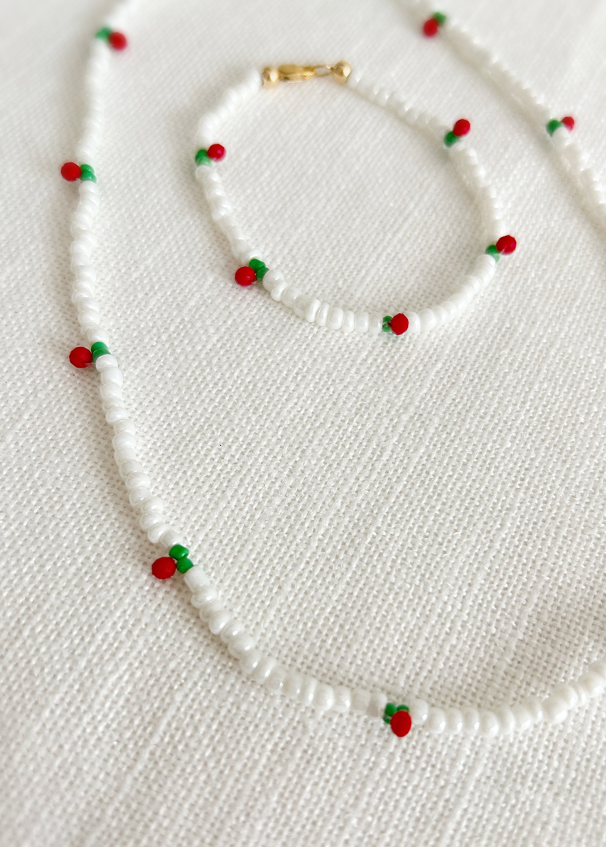 White seed bead Necklace with red and green cherry design beads accents 