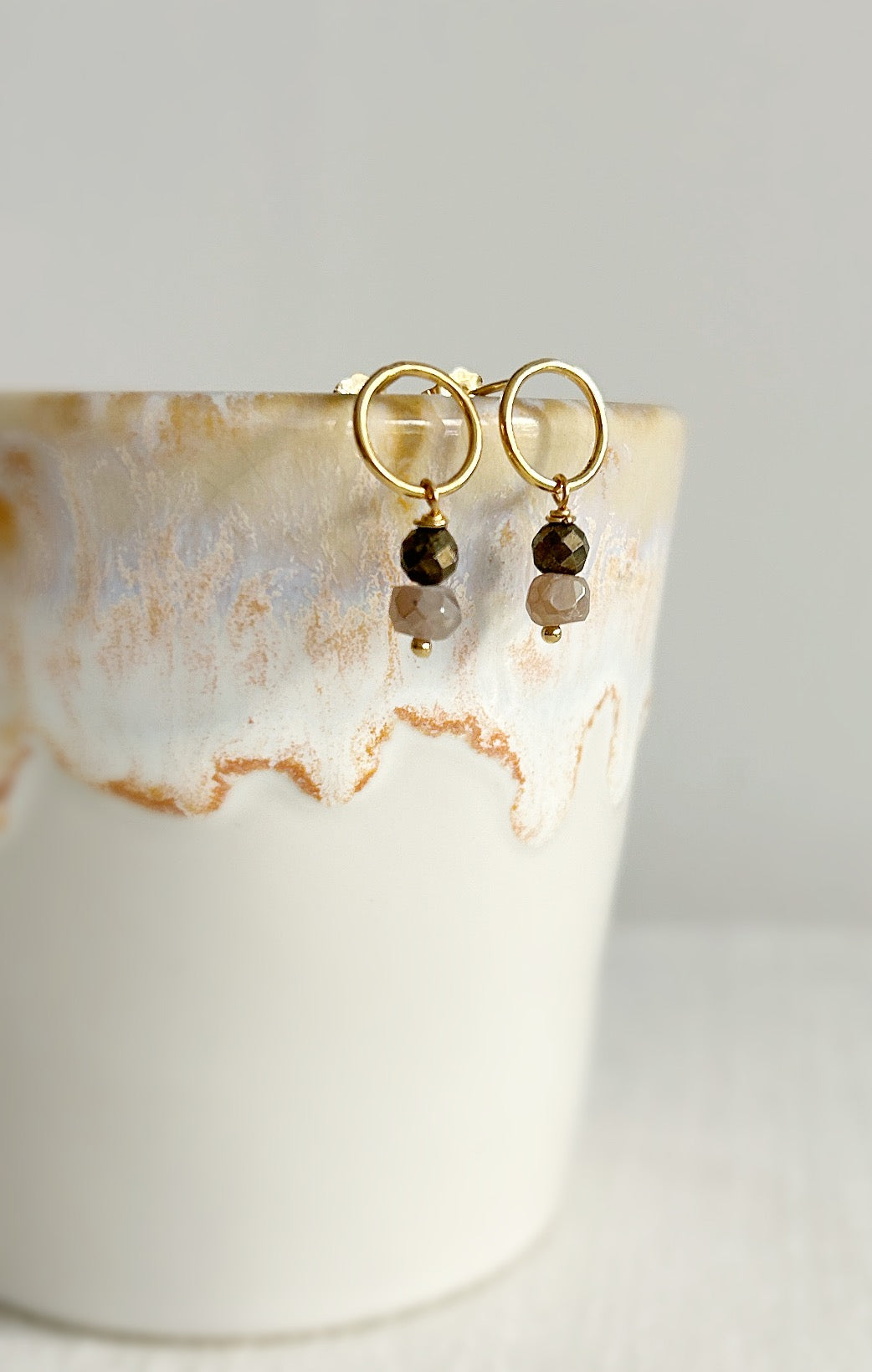 Circle stud earrings with two dangling crystal beads