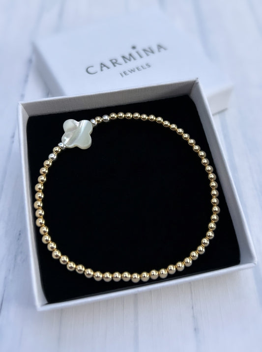 A gold-filled Mother of Pearl clover bracelet with silver beads, presented in a Carmina Jewels box.