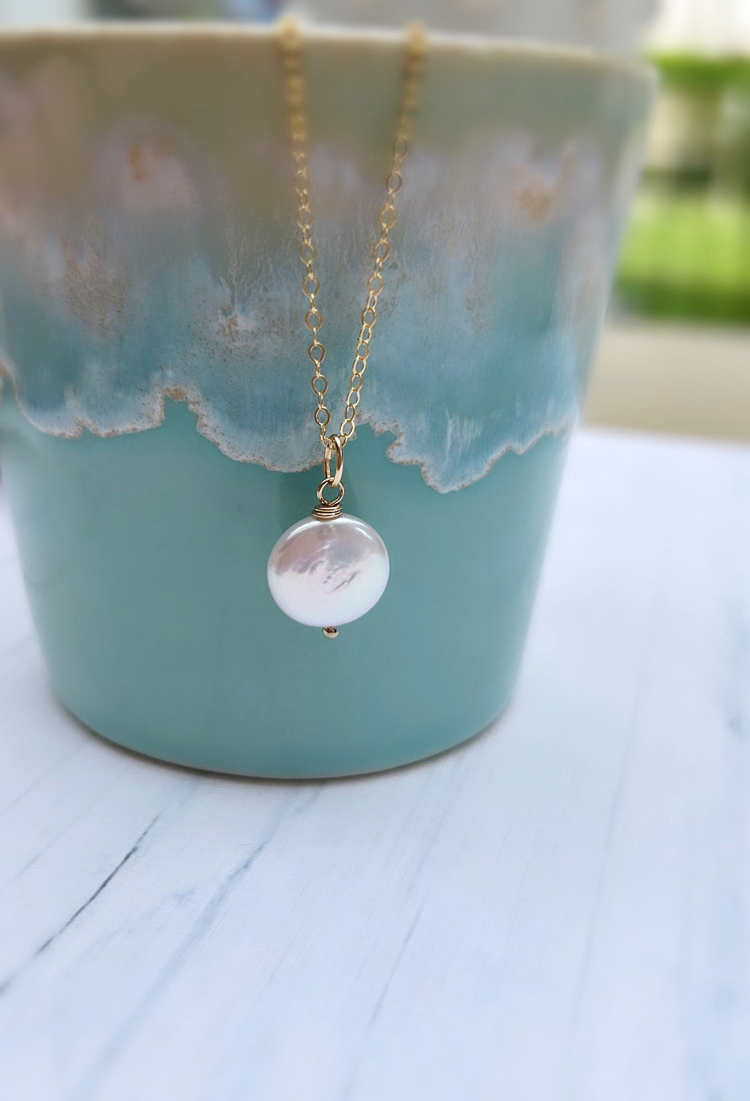 A beautiful coin shaped Freshwater Pearl pendant,  available on a Sterling Silver or Gold Filled delicate cable chain. 