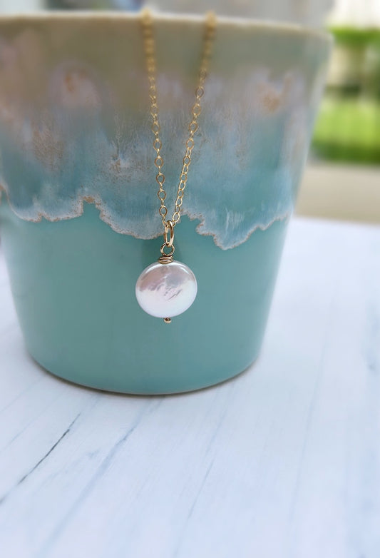 A beautiful coin shaped Freshwater Pearl pendant,  available on a Sterling Silver or Gold Filled delicate cable chain. 