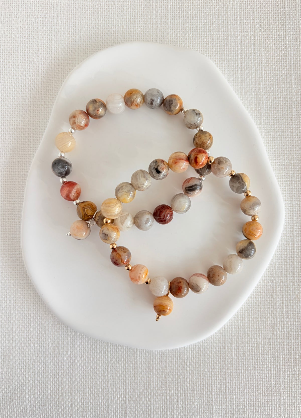 A beautiful grey/beige Crazy lace Agate beaded bracelet accented with Miyuki seed beads in your choice of Gold Filled or Sterling Silver. The 8mm beads are the perfect size to complement your stacks of smaller bracelets and bangles.
