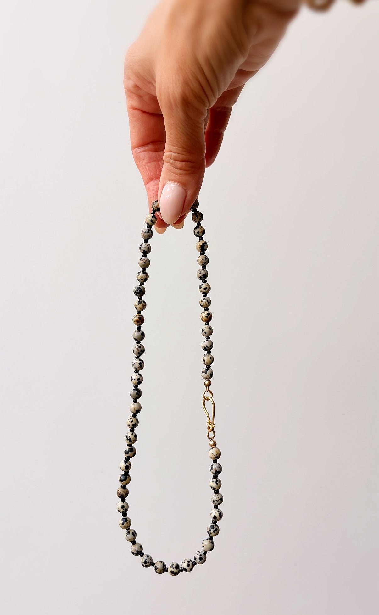 This gorgeous beaded necklace is the perfect accessory for any season. Made using semi precious Dalmatian Jasper beads.   

The necklace is finished with a decorative ‘S’ style clasp fastener in either a Gold Vermeil or Sterling Silver finish. The necklace length is 18”.