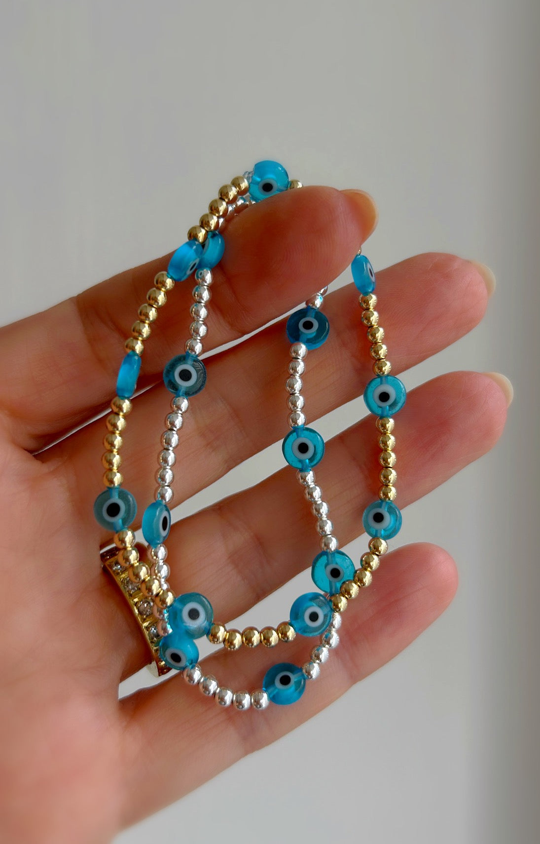 Pretty handmade Murano glass lucky ‘evil’ eye charm bracelet in a Sterling Silver or Gold Filled finish. Choose from either blue or turquoise glass ‘eye’ beads. 