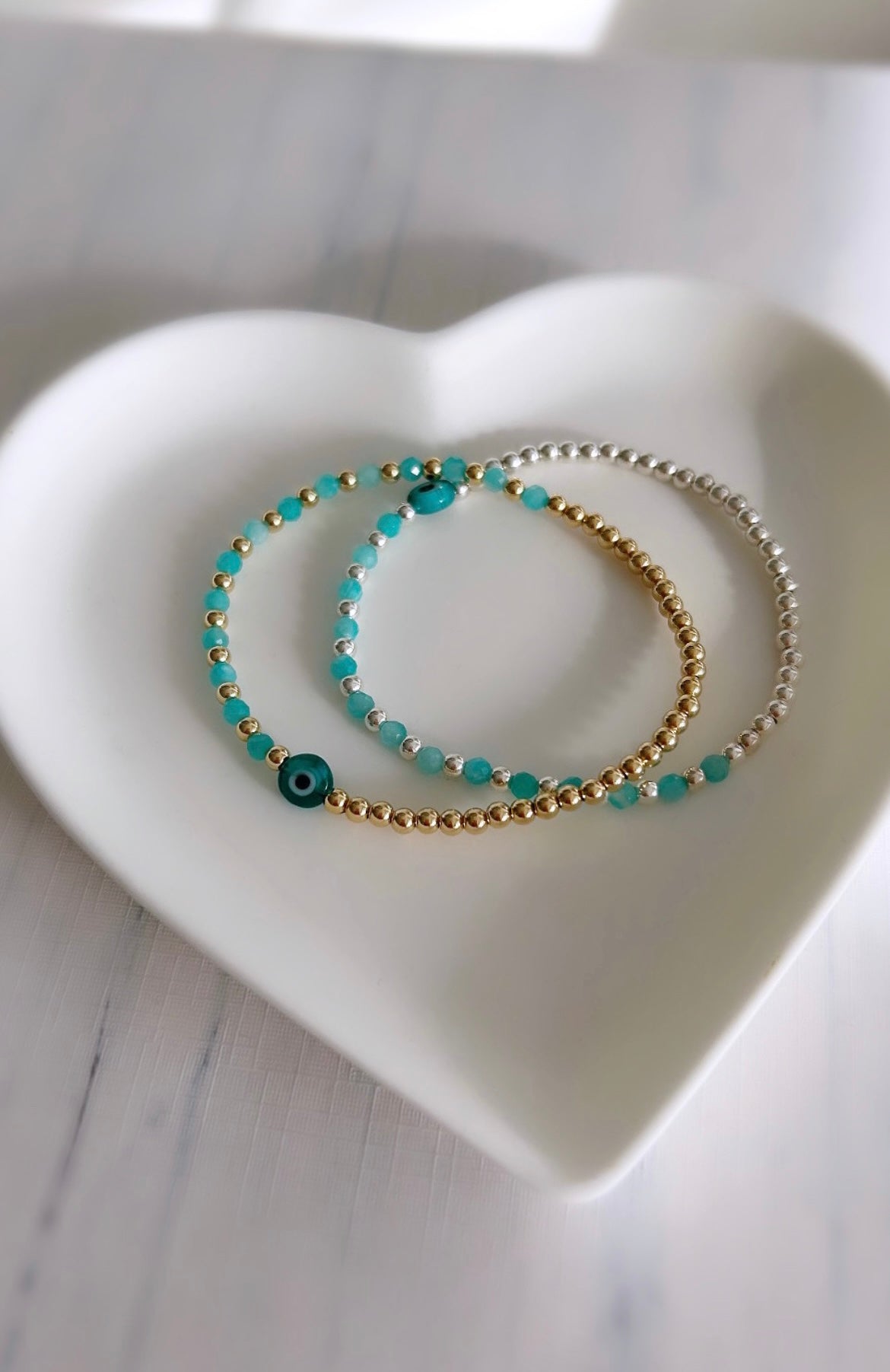 Pretty handmade Murano glass lucky ‘evil’ eye charm bracelet with Amazonite glass crystal beads, either in a Sterling Silver or Gold Filled finish. The bracelets are hand threaded on a high quality stretch cord.