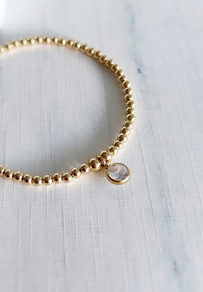 Beautiful crystal gemstone bracelets, perfect for stacking! Choose from either - Sterling Silver or a Gold Filled finish with a sparkling Cubic Zirconia charm.