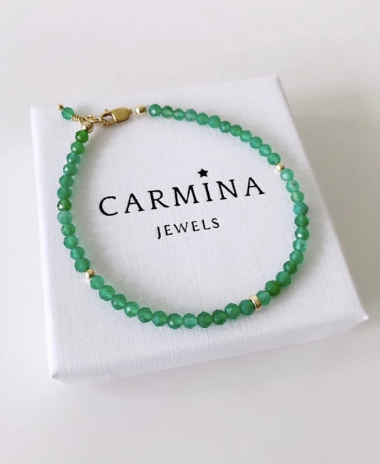 A green aventurine crystal bracelet with gold spacer beads presented in a white box with 'CARMINA JEWELS' branding.