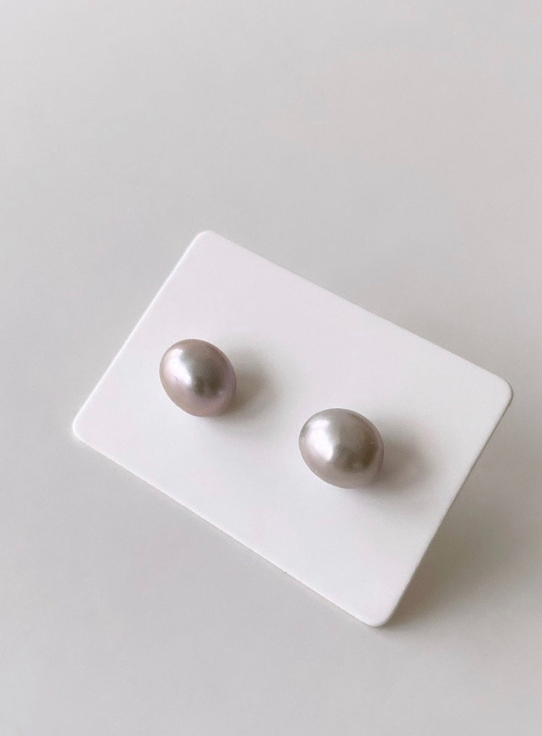 A pair of baroque pearl stud earrings with silver posts and butterfly clasps 