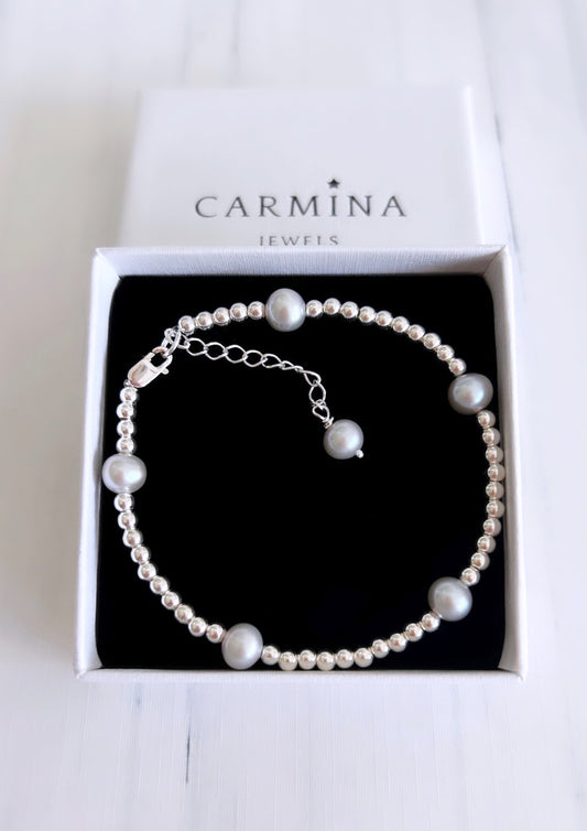 A grey baroque freshwater pearl bracelet with sterling silver beads, presented in a Carmina branded gift box.