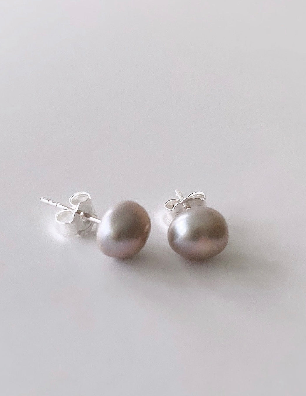 Beautiful silver-grey baroque Freshwater Pearl stud earrings on a Sterling Silver post with Silver butterfly clasps.