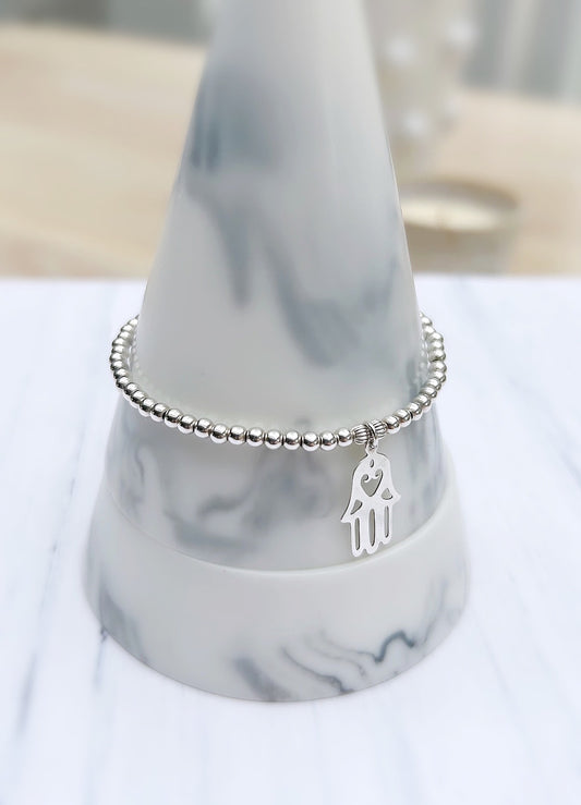 A sterling silver beaded bracelet with a Hamsa charm