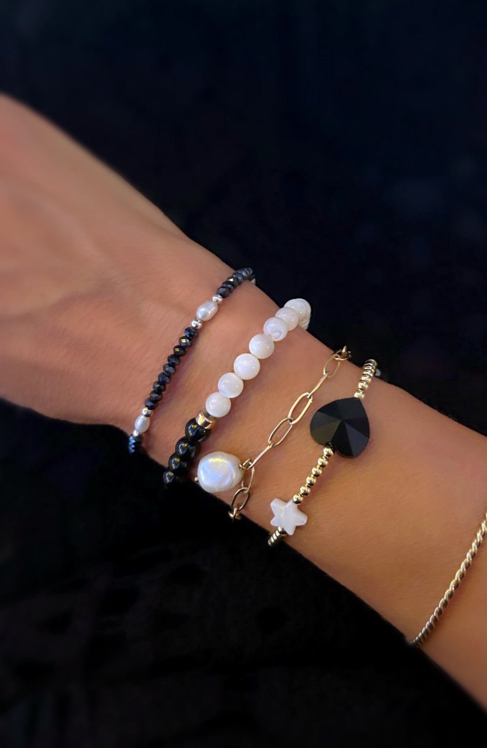 A beautiful stacking bracelet adorned with a charming mix of hearts, stars, and pearls ~ featuring a glass heart bead, a freshwater pearl, a Mother of Pearl heart and star, and a shimmering hematite star.