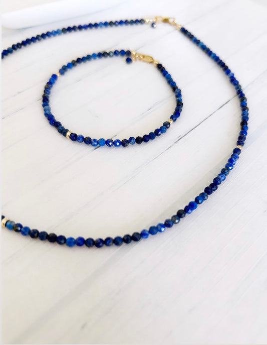 A looped lapis lazuli bead necklace with gold filled spacer beads and a lobster closure clasp