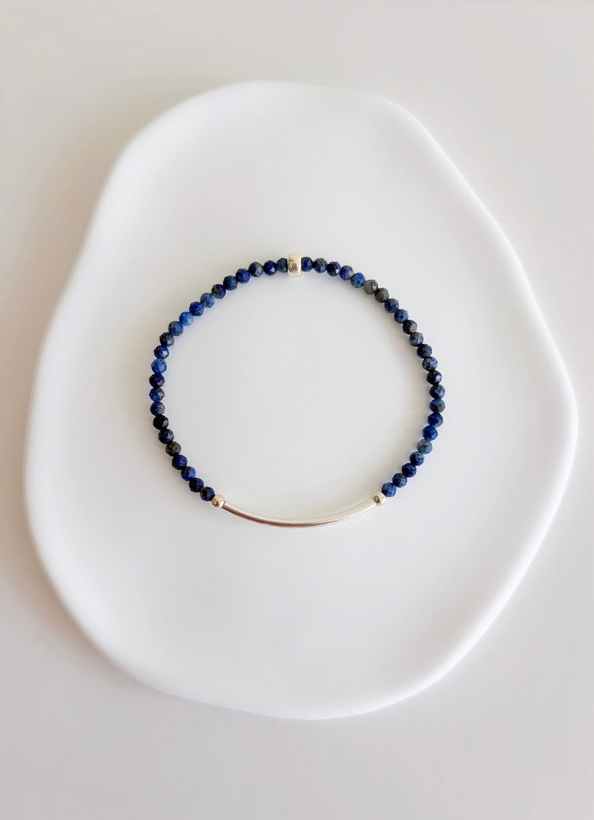 Beautiful Lapis Lazuli semi precious faceted bead bracelet hand threaded on a strong stretch elastic cord. This delicate bracelet comes in a choice of two finishes using either Sterling Silver or Gold Filled accents.
