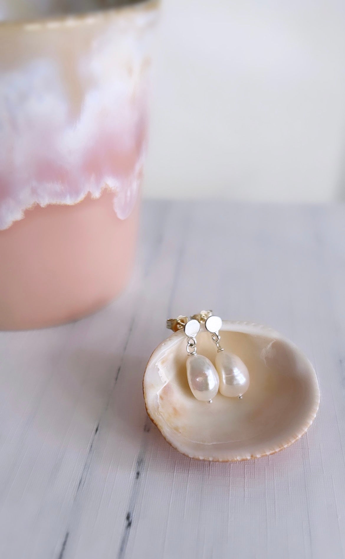 Large baroque Freshwater pearls dangling from a Sterling Silver mini disc ear stud, with butterfly clasp fastenings. The pearls measure approximately 11mm.
