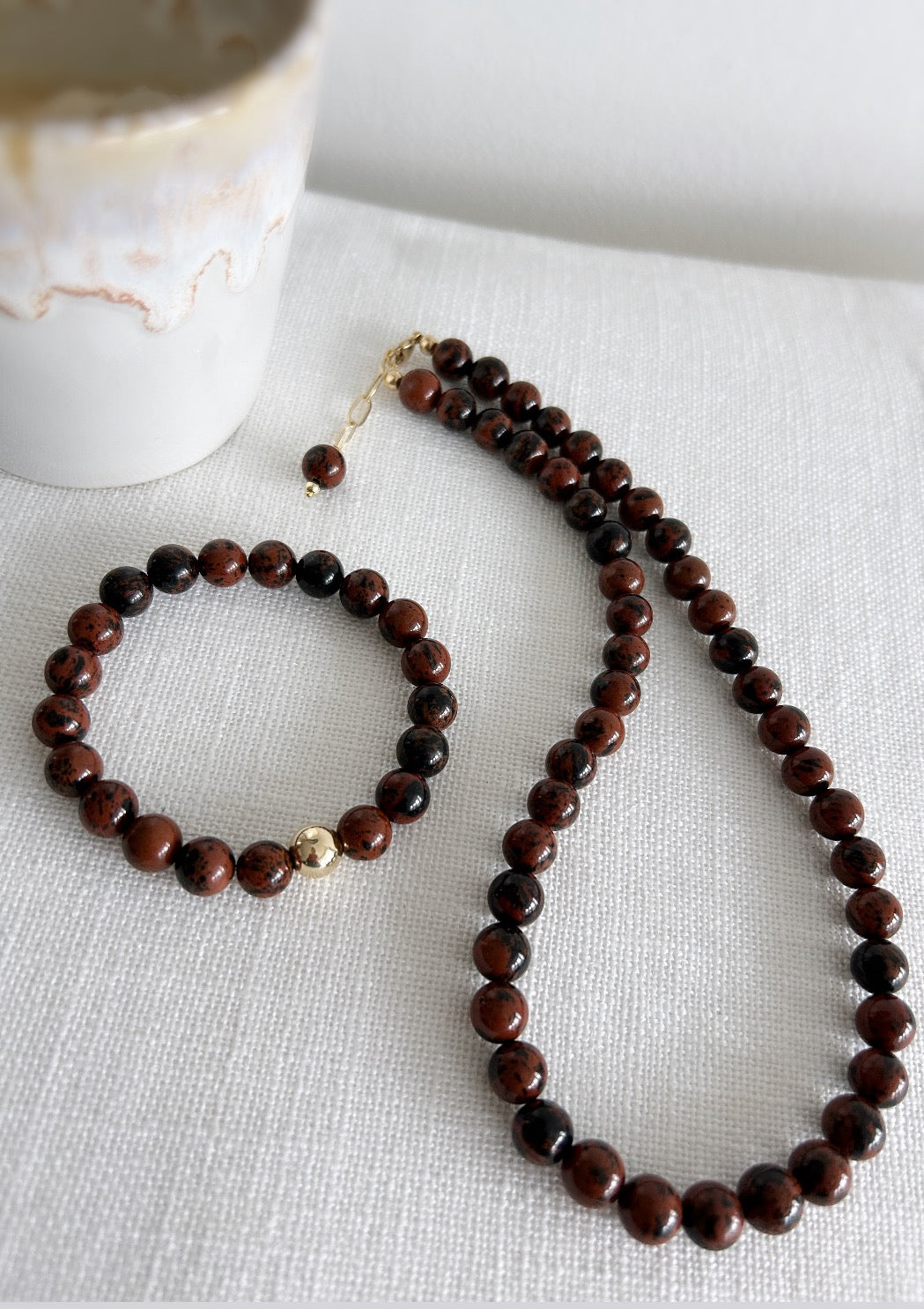 A stunning, richly coloured Golden Obsidian beaded bracelet featuring a central round bead in your choice of Gold Filled or Sterling Silver