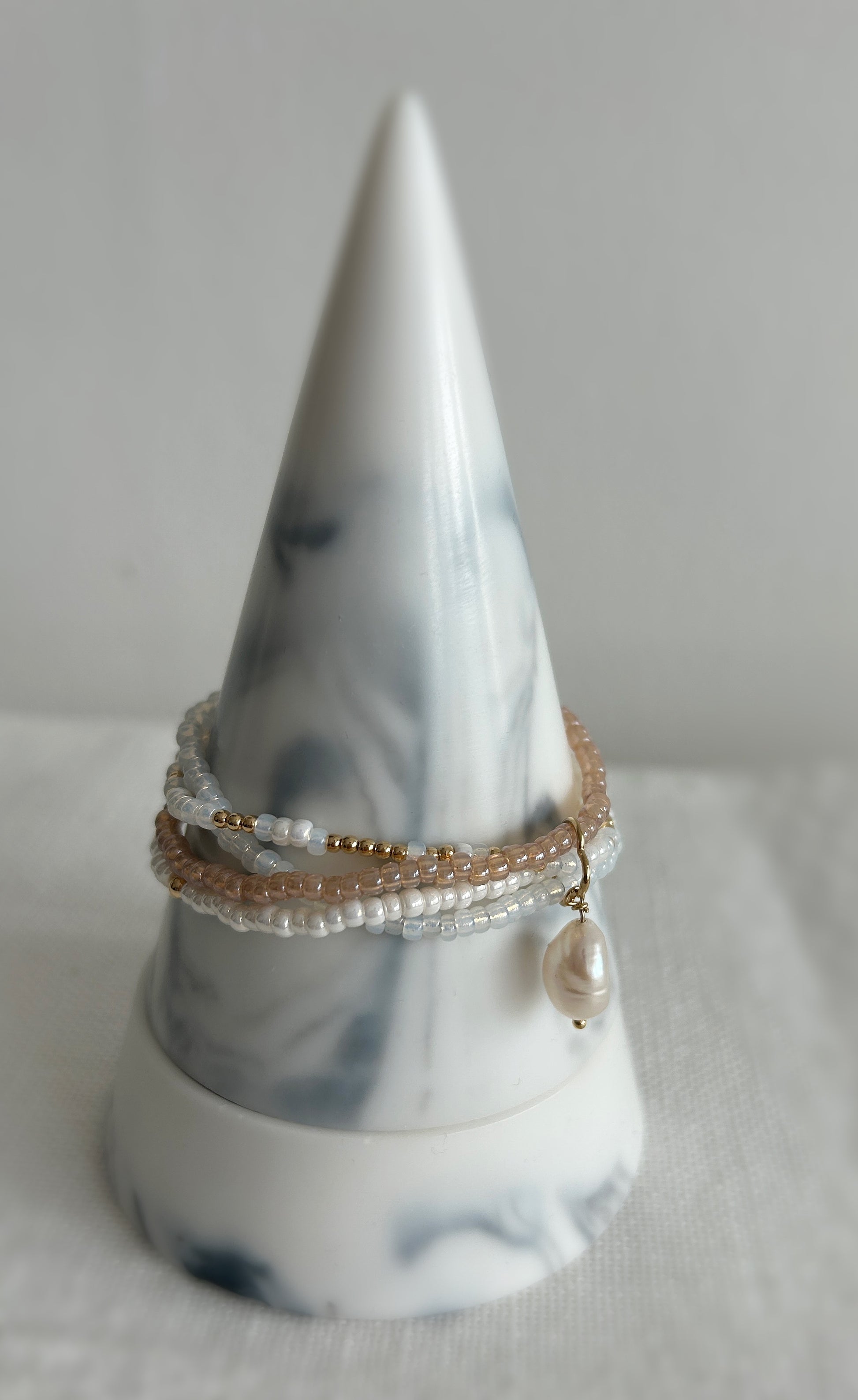 This beautiful multi-strand Miyuki glass seed bead & pearl bracelet is the perfect piece to elevate your jewellery collection. Available in a Sterling Silver or Gold Filled finish. The bracelet features a clover shaped fixture with a single baroque Freshwater Pearl. 
