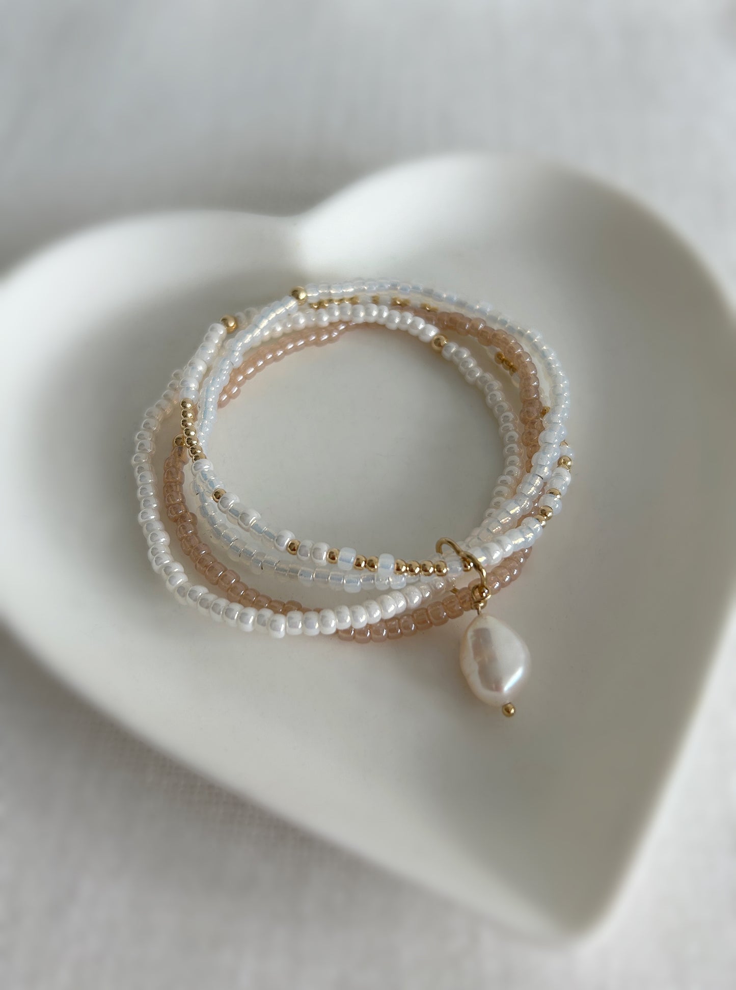 This beautiful multi-strand Miyuki glass seed bead & pearl bracelet is the perfect piece to elevate your jewellery collection. Available in a Sterling Silver or Gold Filled finish. The bracelet features a clover shaped fixture with a single baroque Freshwater Pearl. 
