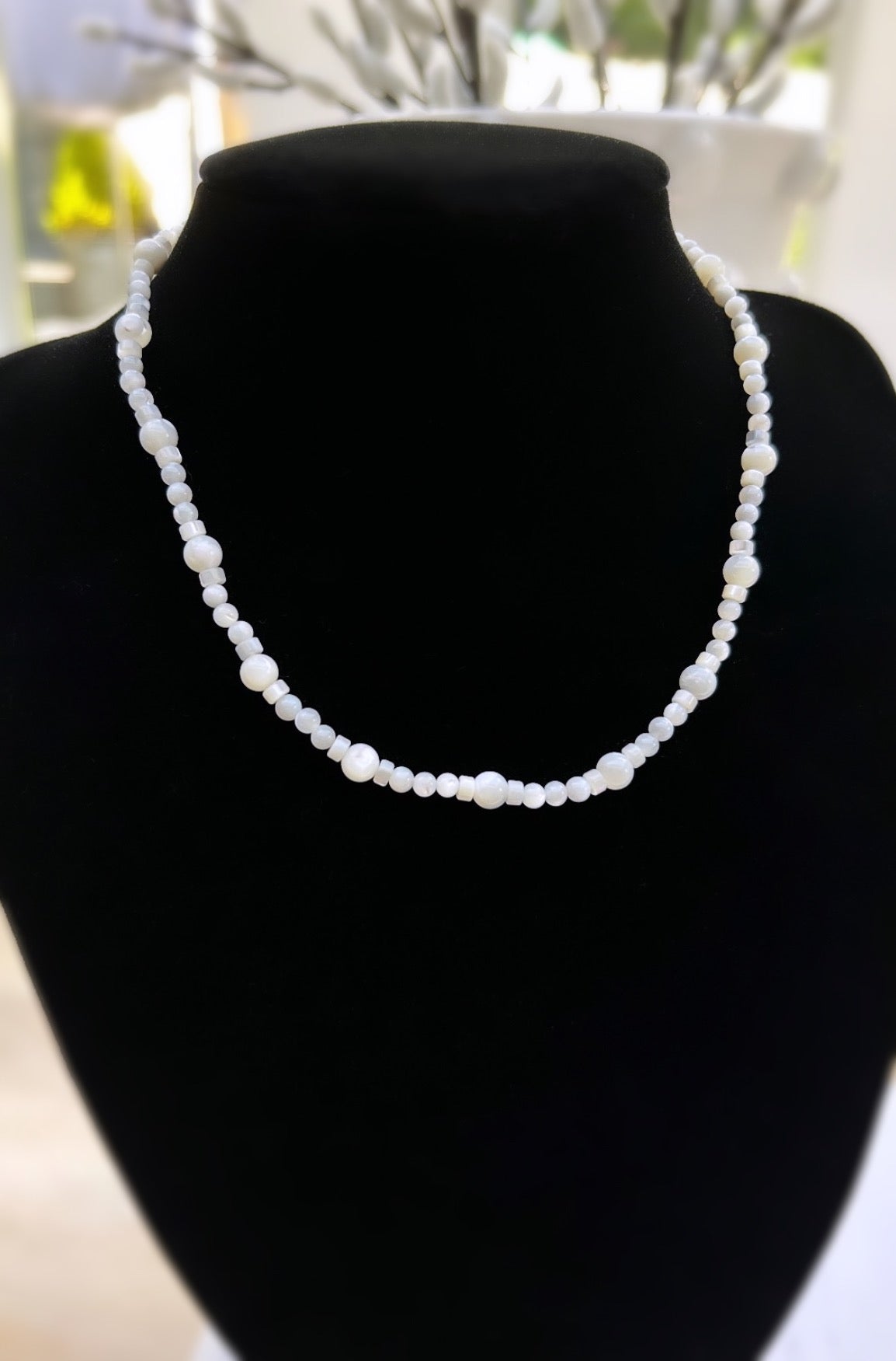 A Mother of Pearl beaded necklace with a lobster clasp