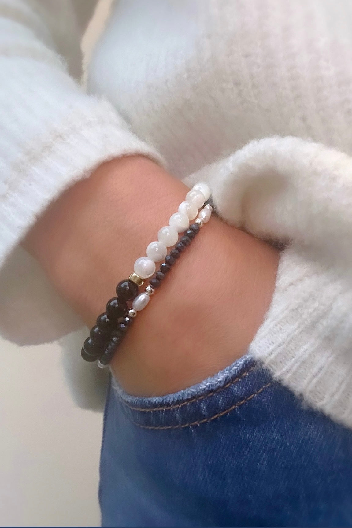 A striking black and white duo bracelet with Black Onyx and Mother of Pearl beads threaded on a stretch cord. 
