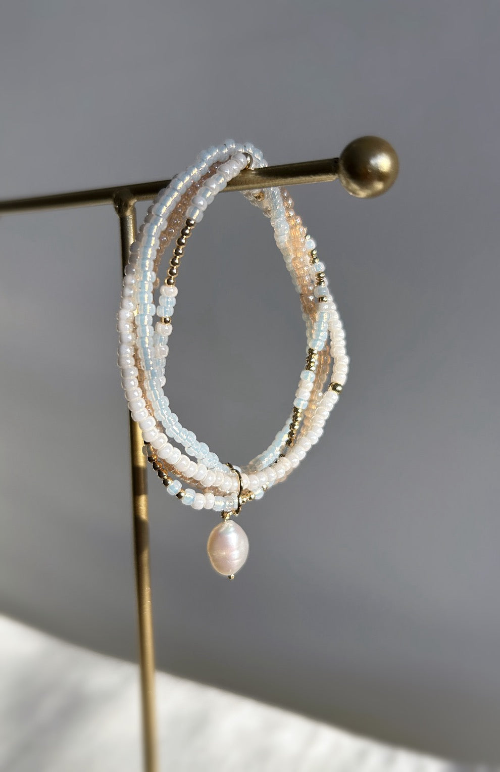 This beautiful multi-strand Miyuki glass seed bead & pearl bracelet is the perfect piece to elevate your jewellery collection. Available in a Sterling Silver or Gold Filled finish. The bracelet features a clover shaped fixture with a single baroque Freshwater Pearl. 
