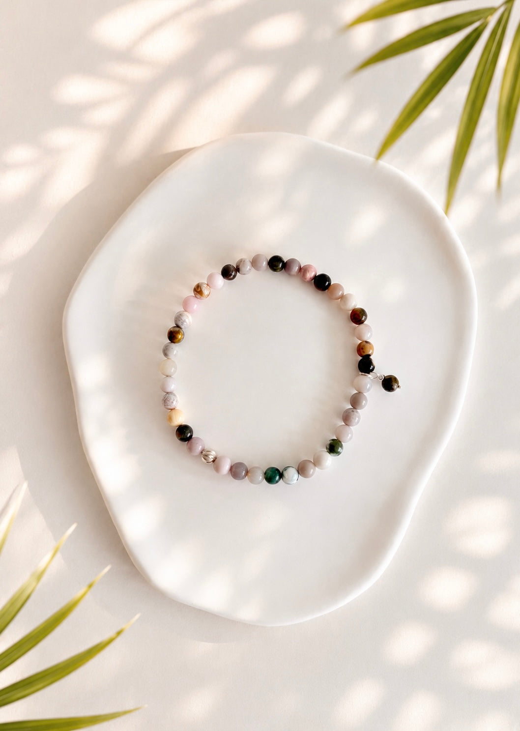 A beautiful semi precious beaded Ocean Jasper stacking bracelet accented with a Sterling Silver twist engraved bead and a Jasper dangle bead, hand threaded on a durable stretch cord.
