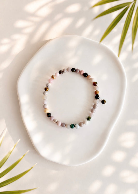 A beautiful semi precious beaded Ocean Jasper stacking bracelet accented with a Sterling Silver twist engraved bead and a Jasper dangle bead, hand threaded on a durable stretch cord.
