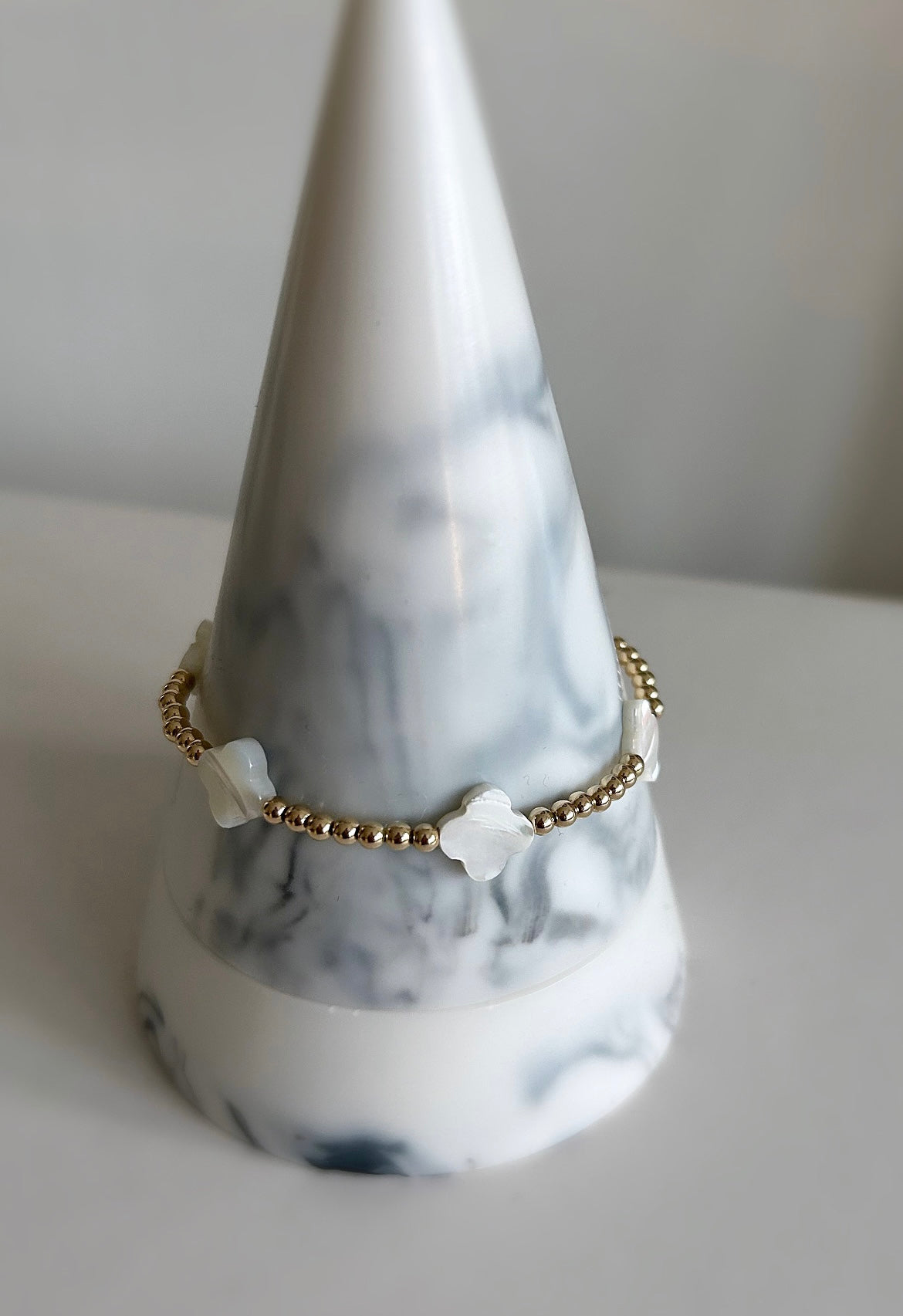 A Mother of Pearl multi Clover beaded stacking bracelet with gold filled or sterling silver finish and silver or gold spacer beads.