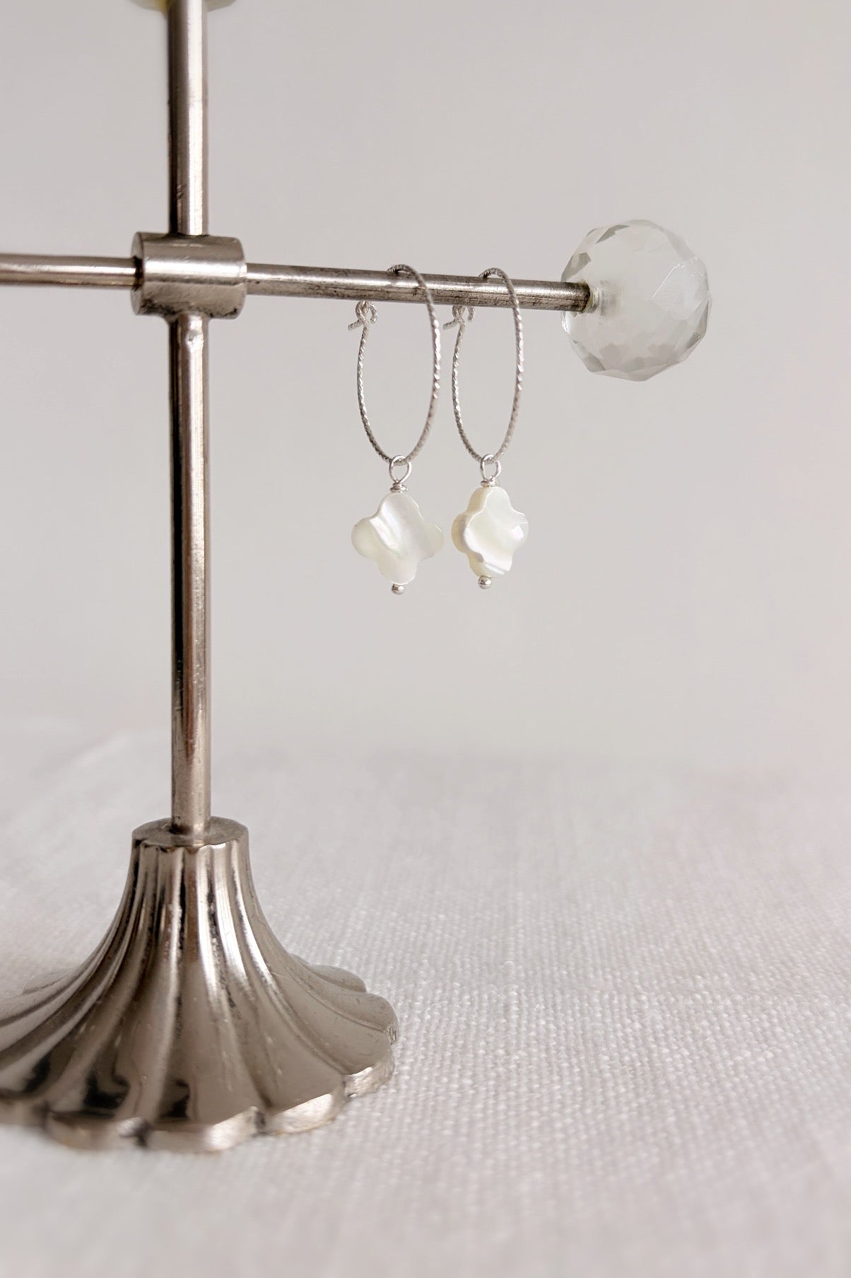 Gorgeous sparkle hoop earrings with Mother of Pearl clover charms. Available in either a Sterling Silver or Gold Filled finish. 
