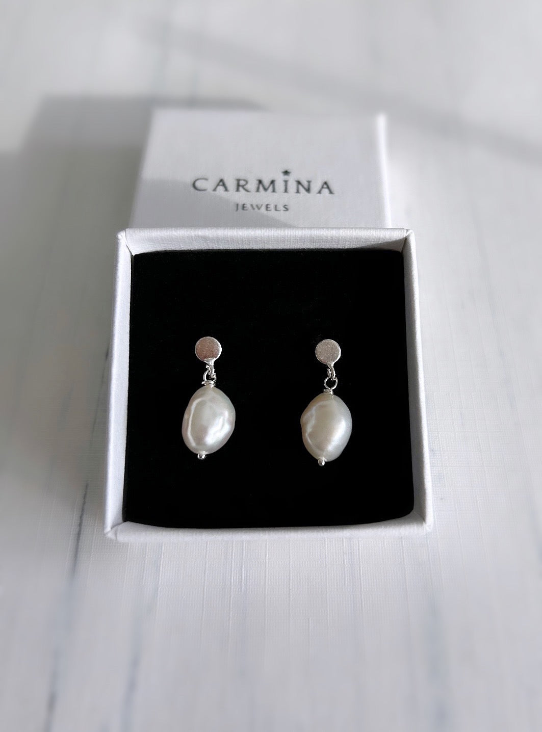 Large baroque Freshwater pearls dangling from a Sterling Silver mini disc ear stud, with butterfly clasp fastenings. The pearls measure approximately 11mm.
