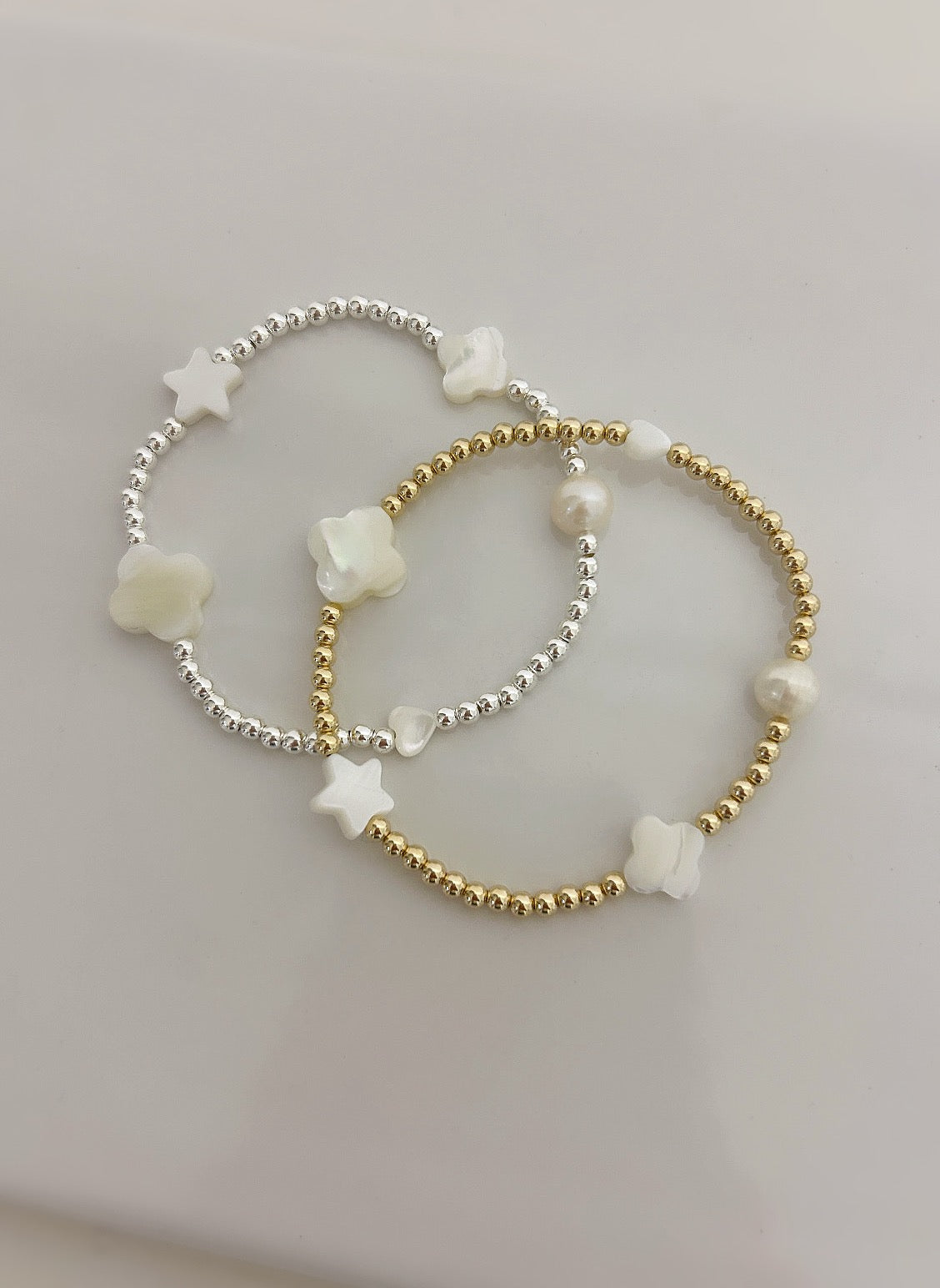 This beautiful stacking bracelet is adorned with a charming mix of hearts, stars, and pearls and clovers ~ featuring a freshwater pearl, a Mother of Pearl heart, star and clovers