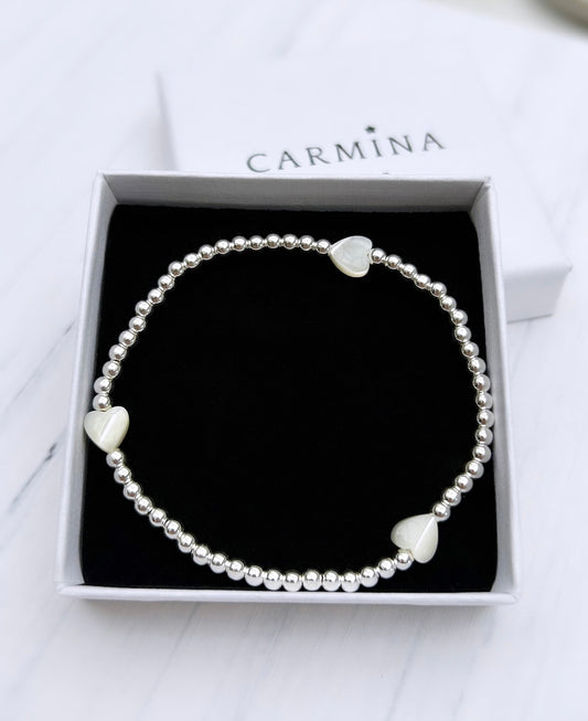 A Mother of Pearl heart bracelet with Sterling Silver beads, presented in a box with the Carmina brand visible.