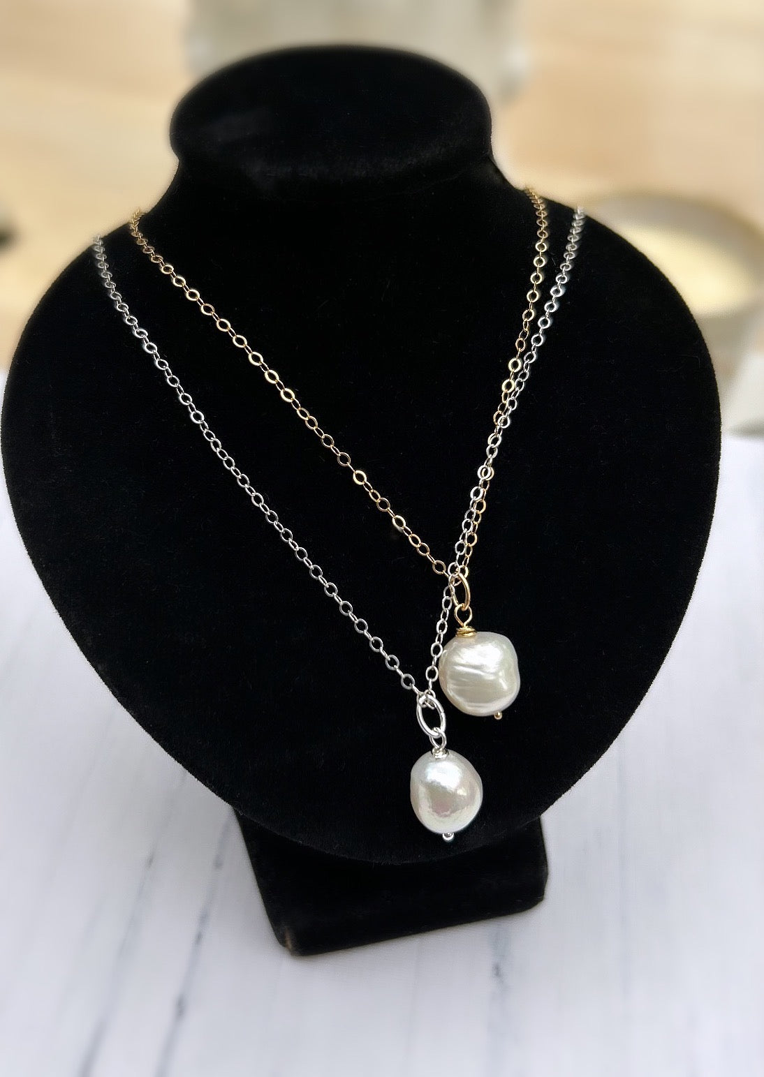 A Freshwater Pearl pendant necklace on a delicate cable chain. The necklace features a baroque style pearl.